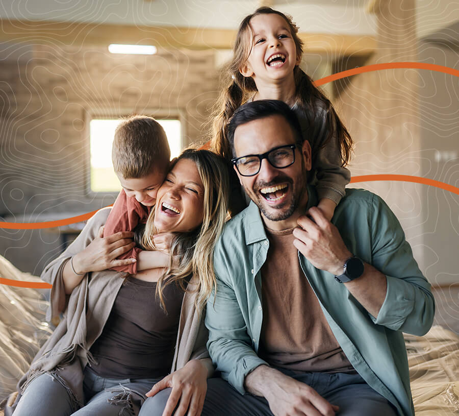 Family of four laughing in their home