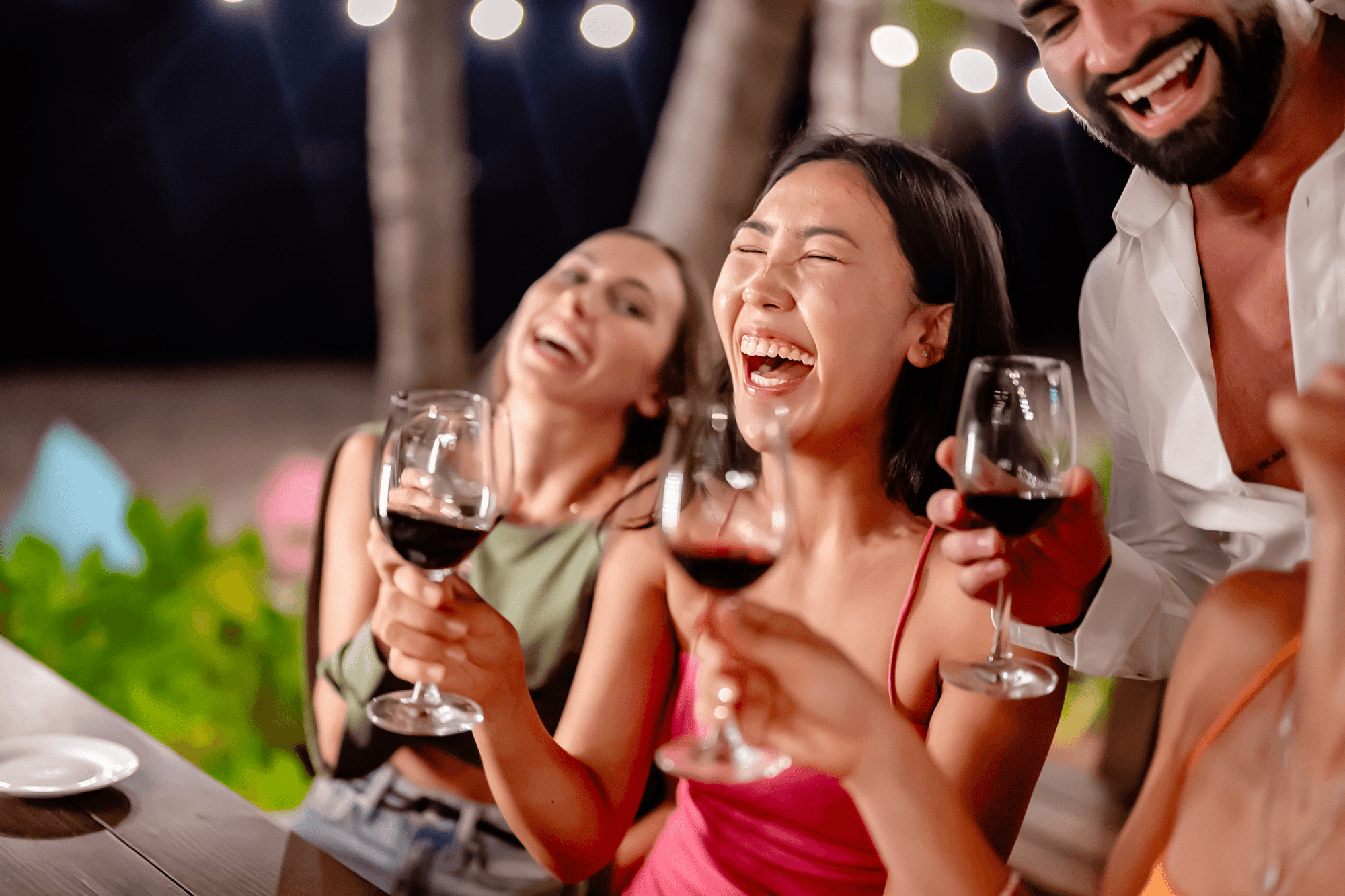 friends laughing while enjoying a beverage