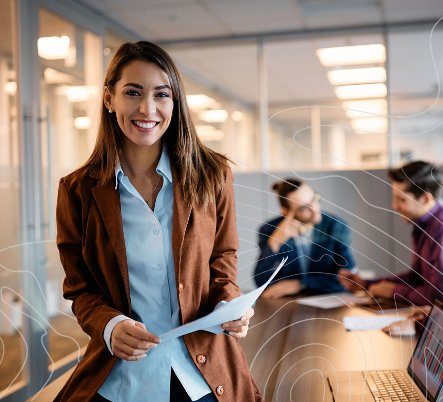 A woman standing and smiling with a career at Red Canoe Credit Union
