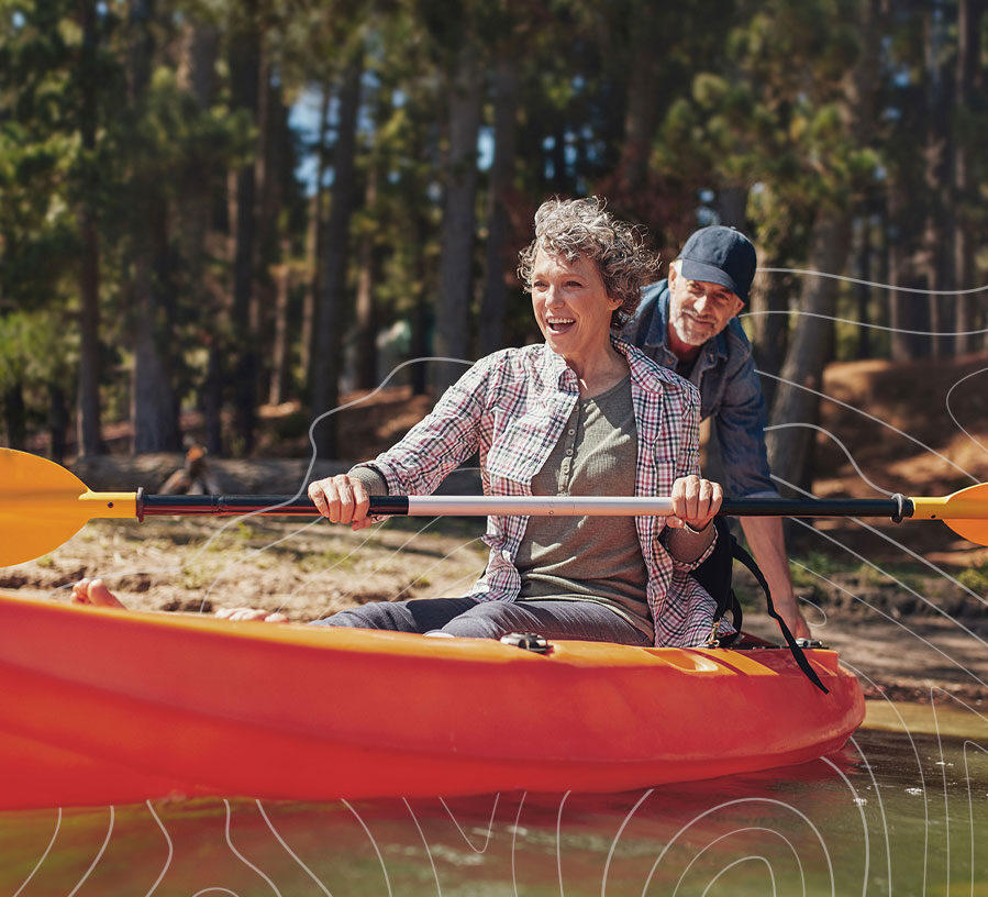 Mature couple kayaking on a lake