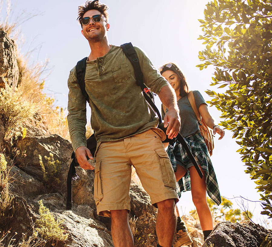 A hiking man and woman smile