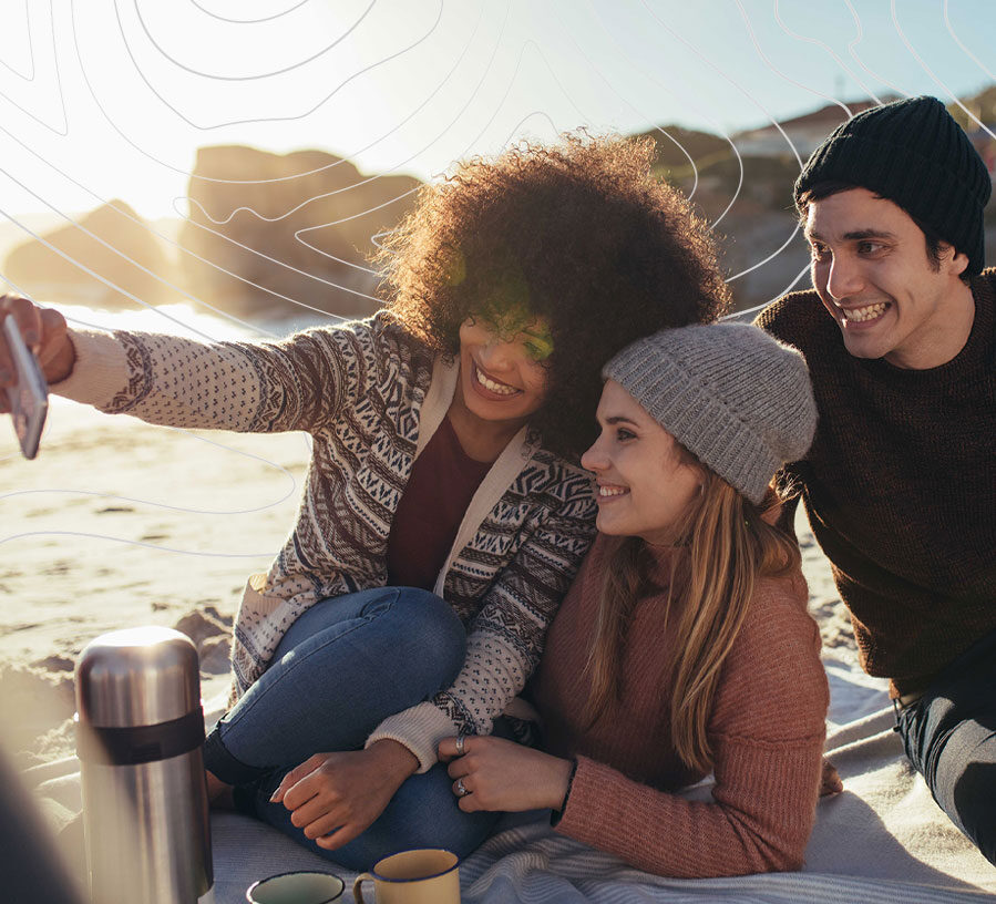 Friend group at beach with Red Canoe Personal Checking Accounts