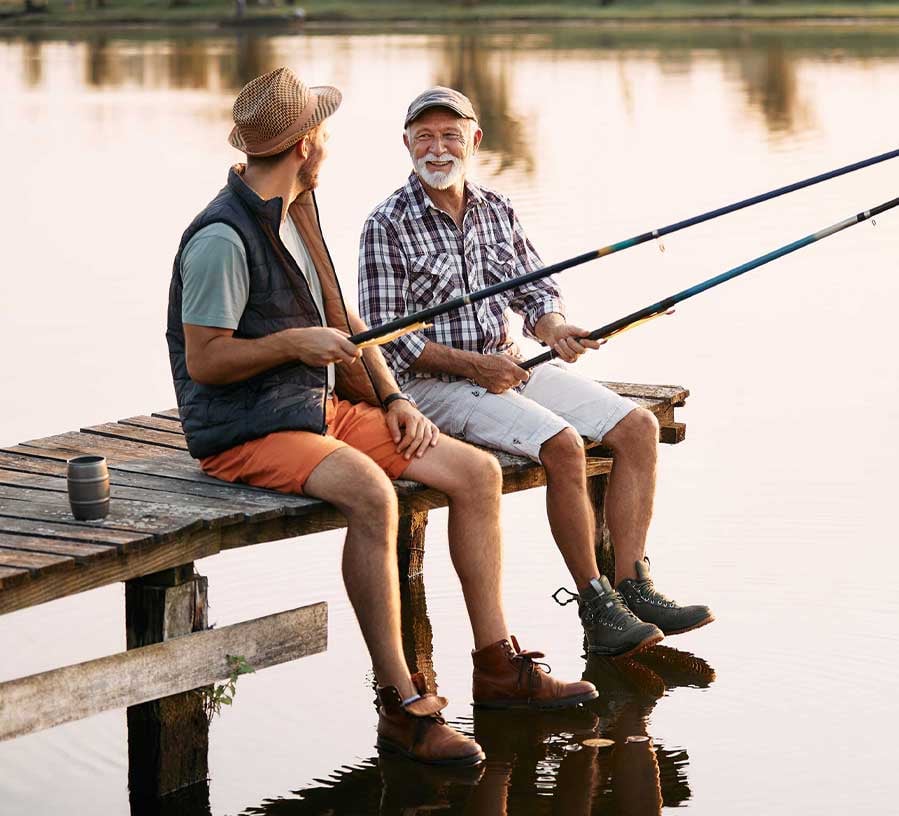 Father and son fishing on a lake with a personal line of credit from Red Canoe