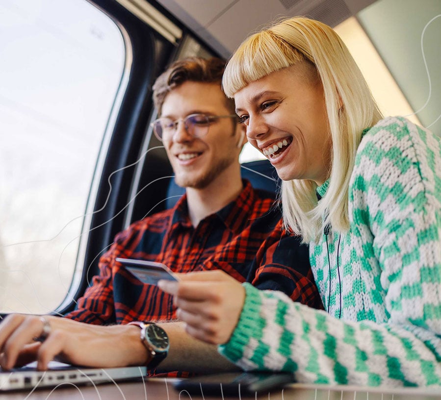 Two young adults look through Adulting Financial Education Topics from Red Canoe Credit Union