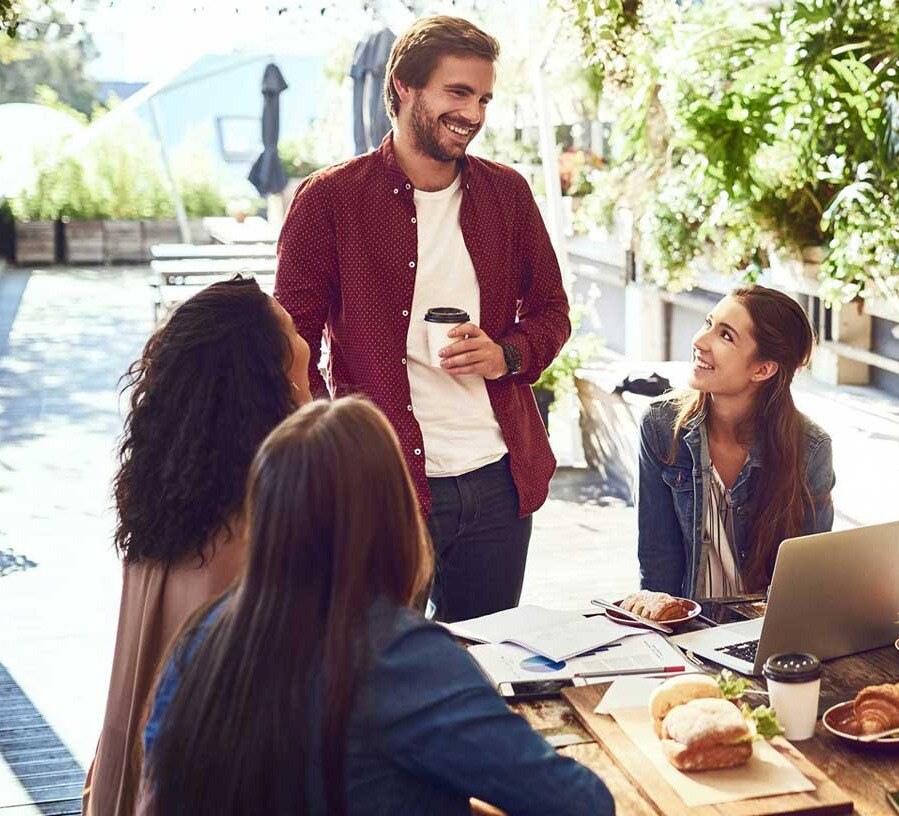 A smiling group of people discuss Educational Downloads from Red Canoe Credit Union