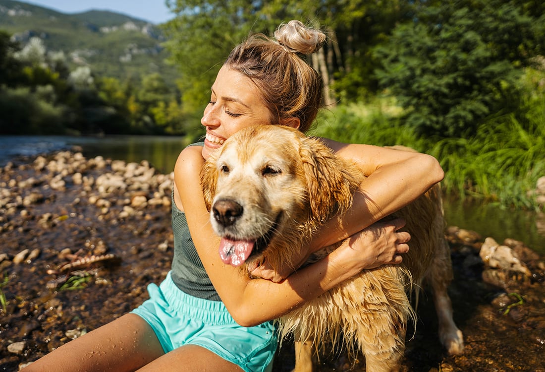 Woman hugging wet dog in Serbia 1