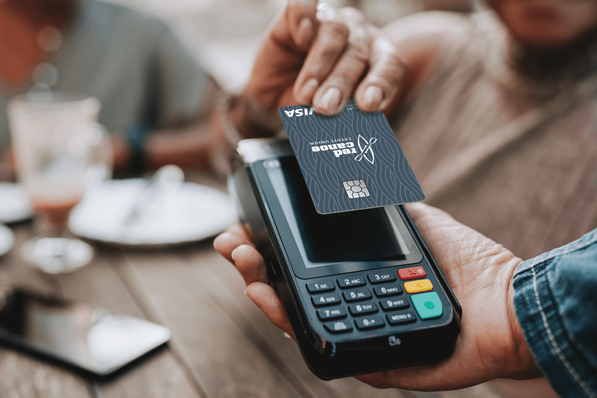 person paying with their Red Canoe Business Credit Card