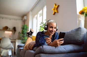 young person online shopping on their couch