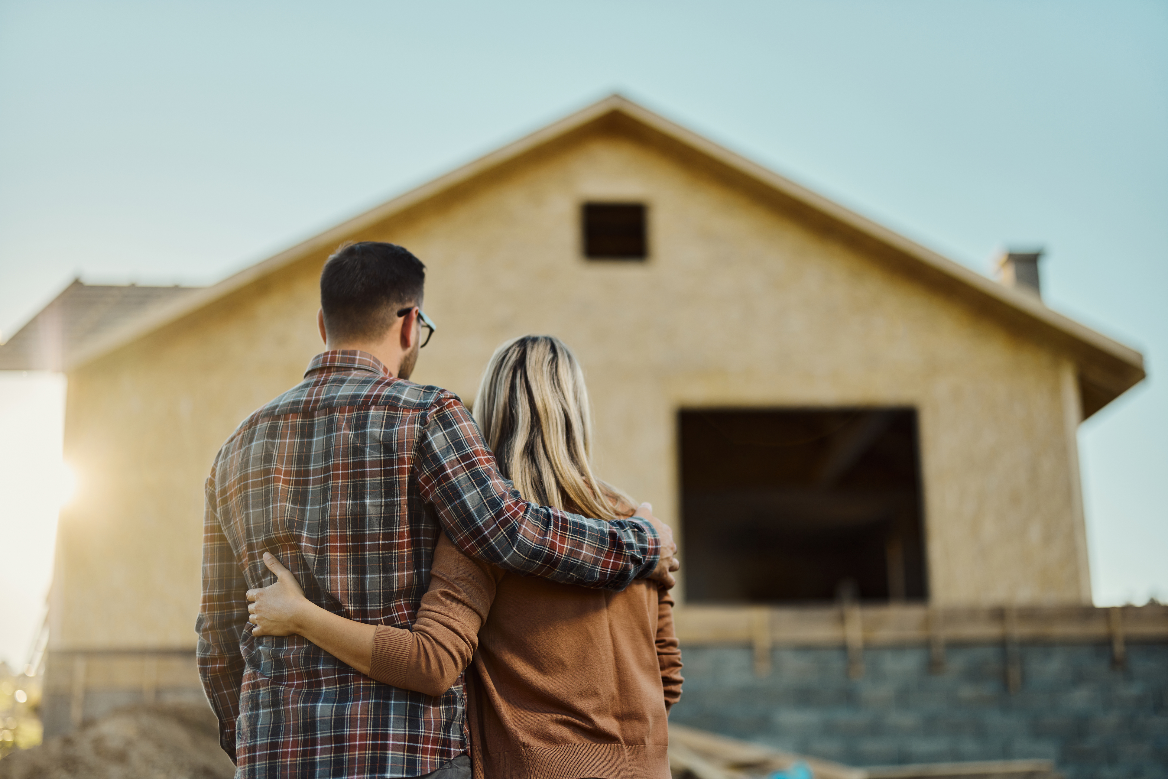 couple looking at a house being built
