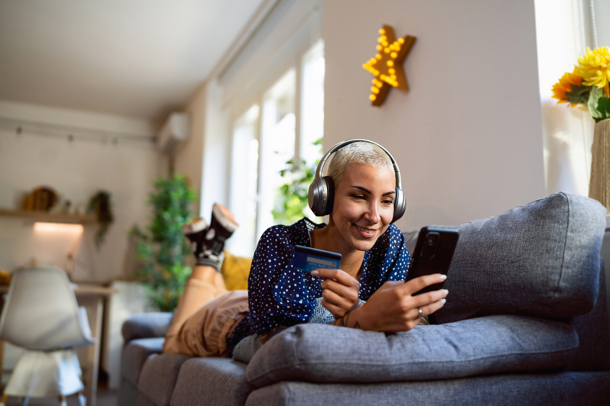 young person online shopping on their couch